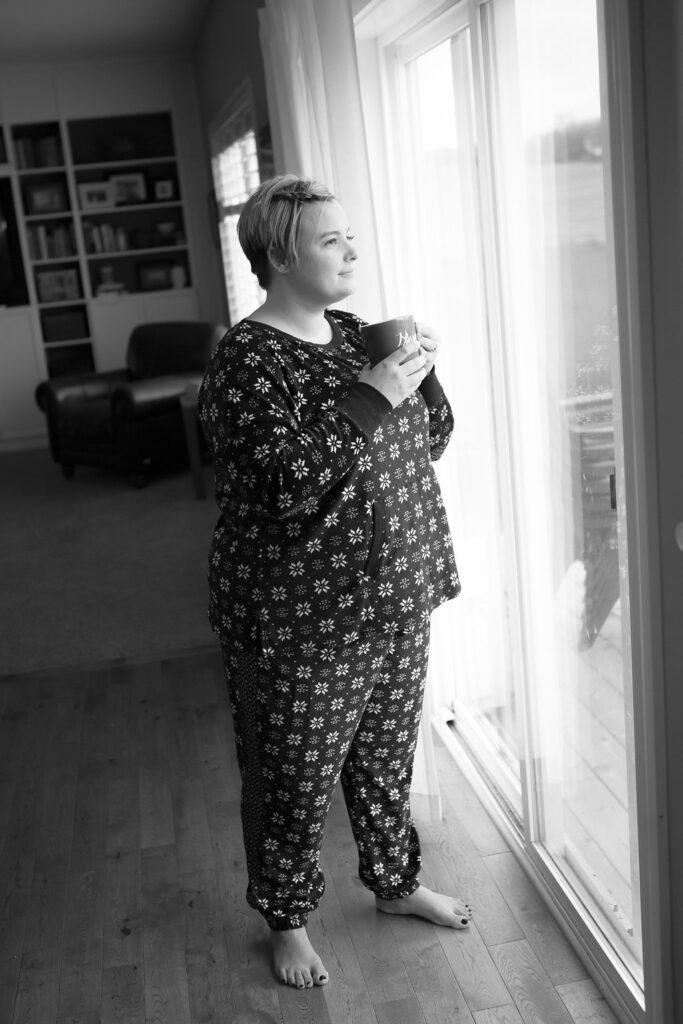 mom drinking coffee looking out the window.