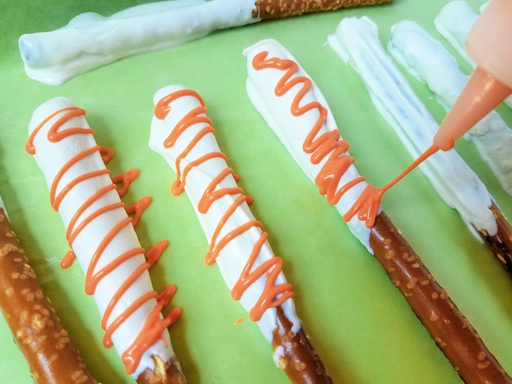 Use orange candy melts in squeeze bottle to create a design