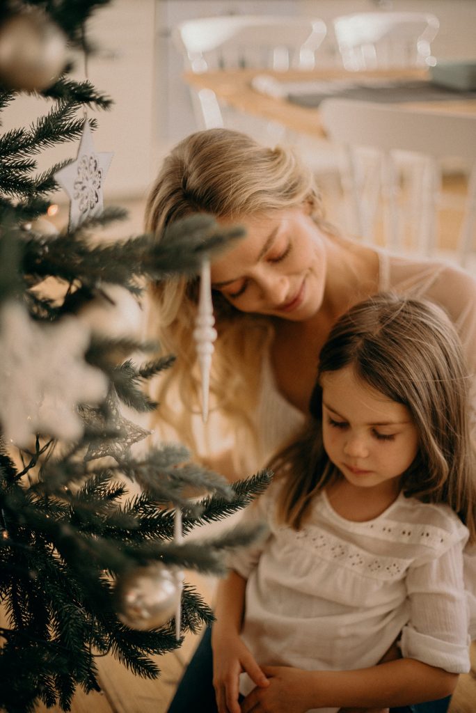 mom and daughter by christmas tree