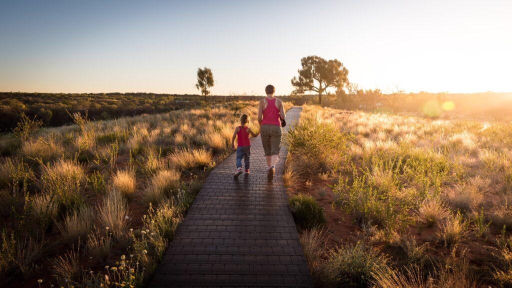 Adult and child walking holding hands
