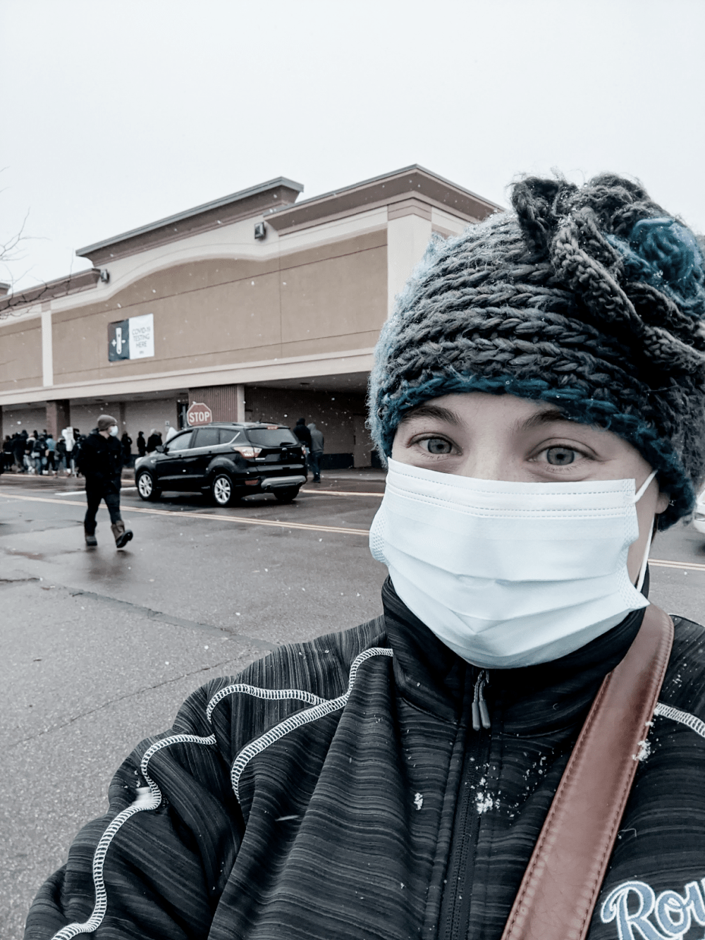 Woman standing with mask on at testing site. Mental illness and a pandemic