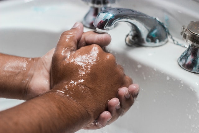 Person washing their hands.
